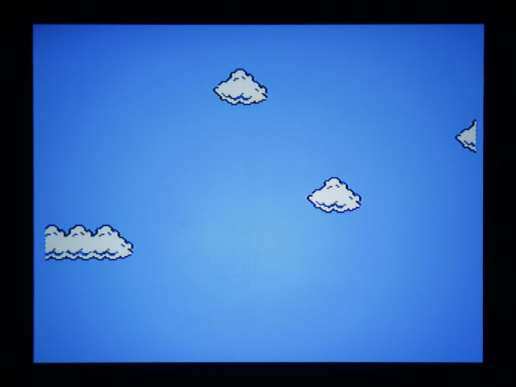 Fig. 5 Photograph of the projected image as played out from NES. There are blue bars on both sides of the image. Photo: Emilie Magnin. Courtesy of the Migros Museum für Gegenwartskunst.